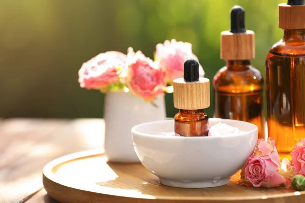 Bottles Rose Essential Oil Flowers Wooden Table Outdoors — Stockfoto