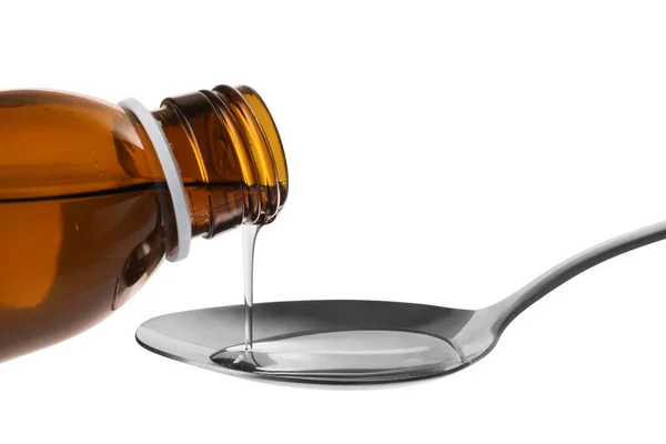 stock image Pouring syrup into spoon from bottle isolated on white, closeup. Cough and cold medicine