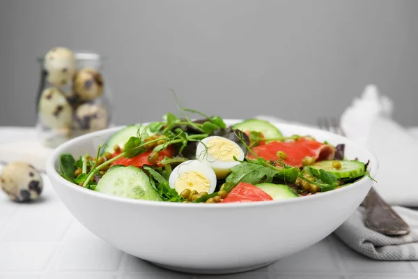 stock image Bowl of salad with mung beans on white tiled table