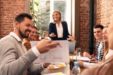 Businesswoman having meeting with her employees in office. Lady boss clipart