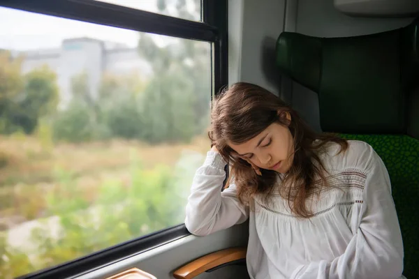 Teenage girl sleeping in train during trip