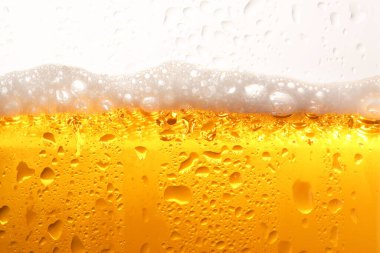 Glass of tasty cold beer with foam and condensation drops on white background, closeup clipart