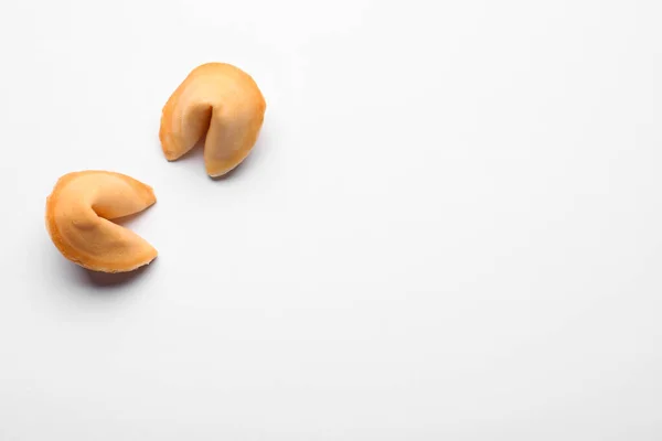 Stock image Tasty fortune cookies with predictions on white background, above view. Space for text