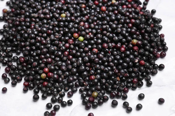 stock image Pile of tasty elderberries (Sambucus) on table, top view