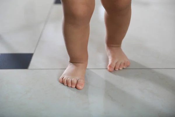 stock image Cute baby learning to walk indoors, closeup