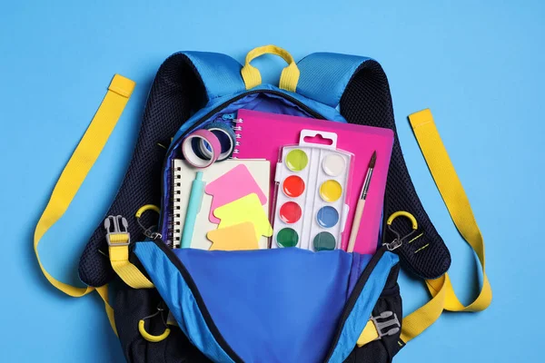 Backpack School Stationery Light Blue Background Top View — Stockfoto