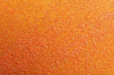 Turuncu arka planda parlak parlak parıltı, düz uzanmış.