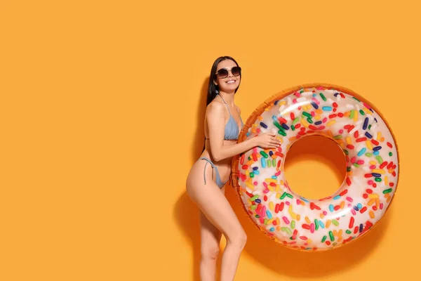 Young Woman Stylish Sunglasses Holding Inflatable Ring Orange Background Space — Stock Photo, Image