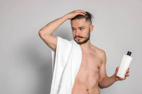 Açık Gri Arka Planda Çıplak Adam Bir Şişe Şampuan — Stok fotoğraf