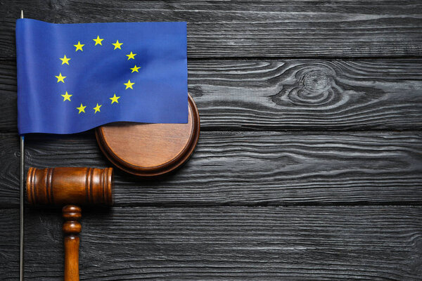 Judge's gavel and flag of European Union on black wooden table, flat lay. Space for text