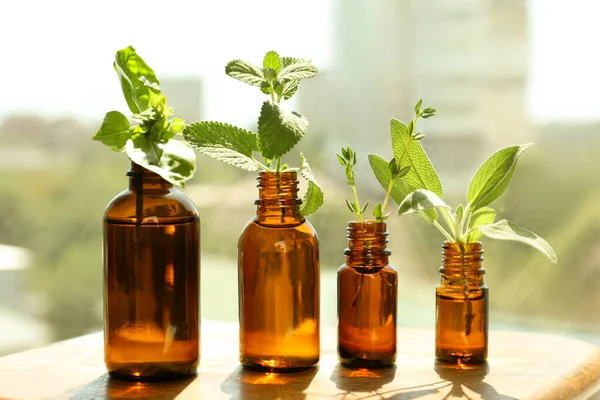 Bottles Essential Fresh Herbs Wooden Table Indoors — Stock Photo, Image
