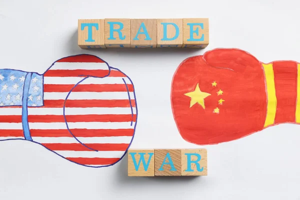 言葉で木製のキューブ貿易戦争 白い紙に描かれたアメリカと中国のフラグを持つボクシンググローブ トップビュー — ストック写真