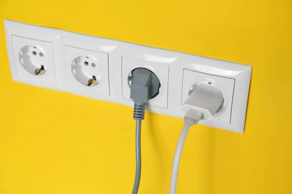 Power Sockets Inserted Plugs Yellow Wall Closeup Electrical Supply — Foto de Stock