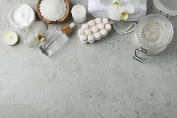 stock image Flat lay composition with different spa products and burning candles on light grey table. Space for text