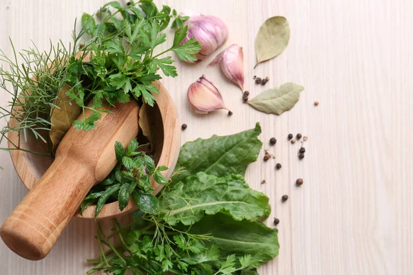 stock image Mortar with pestle and different ingredients on wooden table, flat lay. Space for text