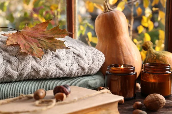 Burning Scented Candles Warm Sweaters Book Pumpkins Wooden Table Window — Stock Photo, Image