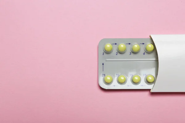 stock image Birth control pills on pink background, top view. Space for text