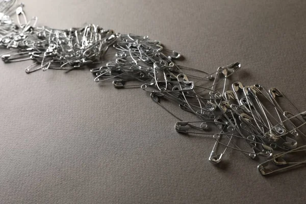 Many Safety Pins Light Grey Textured Background — Stock Photo, Image