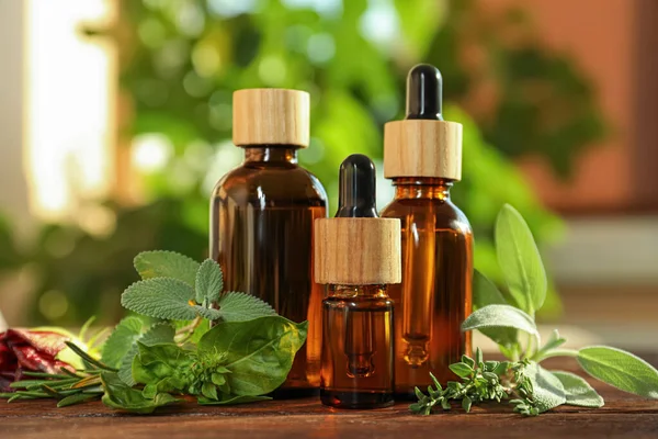 Bottles Essential Oil Fresh Herbs Wooden Table Room — Stock Photo, Image
