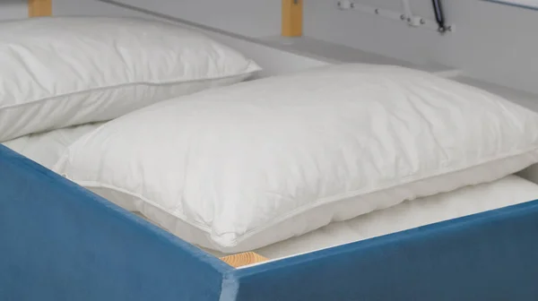 stock image Storage drawer under bed with white pillows indoors, closeup