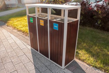Güneşli bir günde atık geri dönüşümü için farklı çöp kutuları.