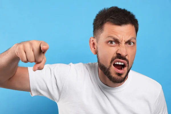 Aggressive Man Pointing Light Blue Background — Stock Photo, Image