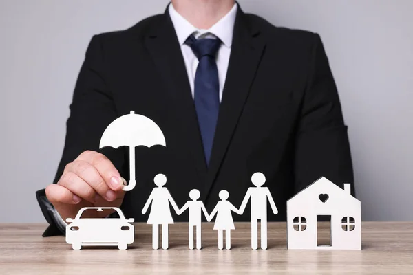 Man Holding Figure Umbrella Family House Car Wooden Table Closeup — Stock Photo, Image