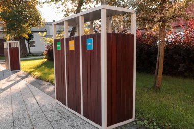 Güneşli bir günde atık geri dönüşümü için farklı çöp kutuları.
