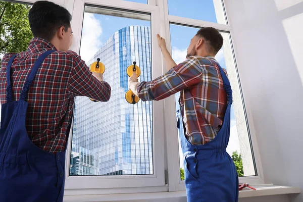 Workers Using Suction Lifters Plastic Window Installation Indoors — Zdjęcie stockowe