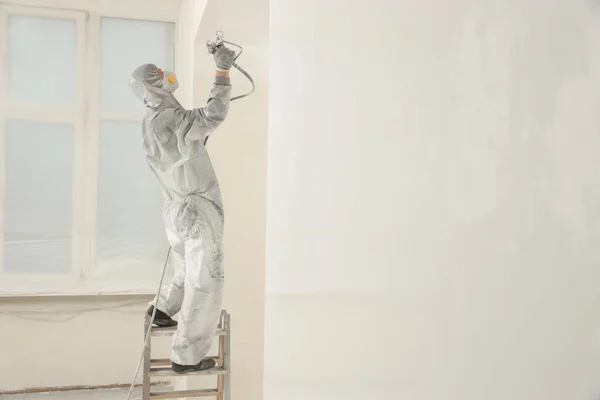 Decorator Protective Overalls Painting Wall Spray Gun Indoors — Stock Photo, Image