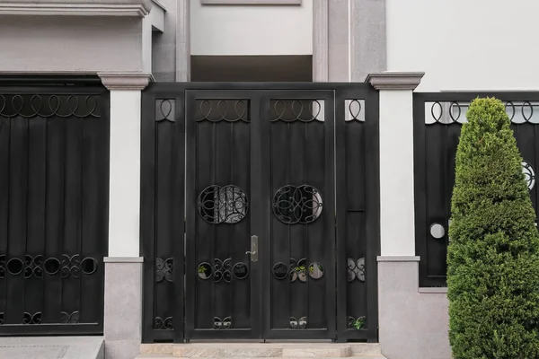 Entrance of yard with beautiful black metal door