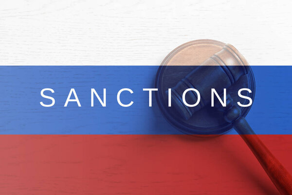 Economic sanctions against Russia because of invasion in Ukraine. Judge's gavel and Russian flag, top view. Double exposure