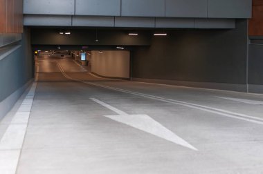 Open parking garage with cars on sunny day clipart