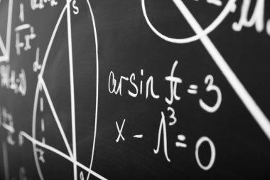 Tahtaya tebeşirle yazılmış matematiksel formüller. Yakın plan.
