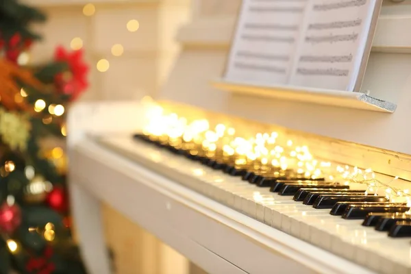 Weißes Klavier Mit Festlichem Dekor Und Notenblättern Drinnen Weihnachtsmusik — Stockfoto