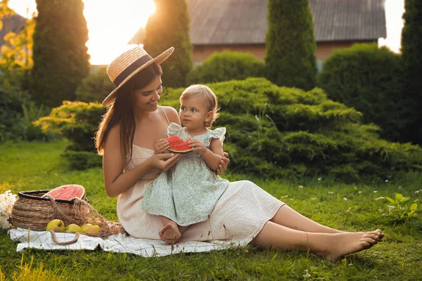 stock image Mother with her baby daughter having picnic in garden on sunny day