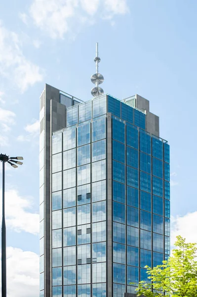 stock image Beautiful building with many windows under cloudy sky