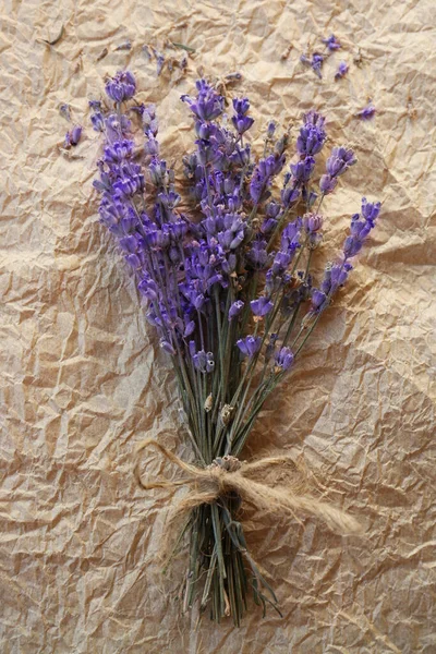 stock image Bouquet of beautiful lavender flowers on parchment paper, top view