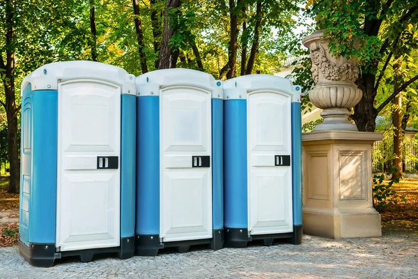 stock image Public toilet cabins on street near trees