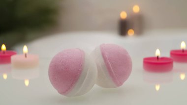 Küvette yanan mumlarla banyo bombaları, yakın çekim. Bokeh etkisi