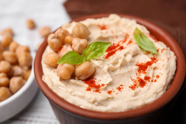 stock image Delicious hummus with chickpeas and paprika served on white wooden table, closeup