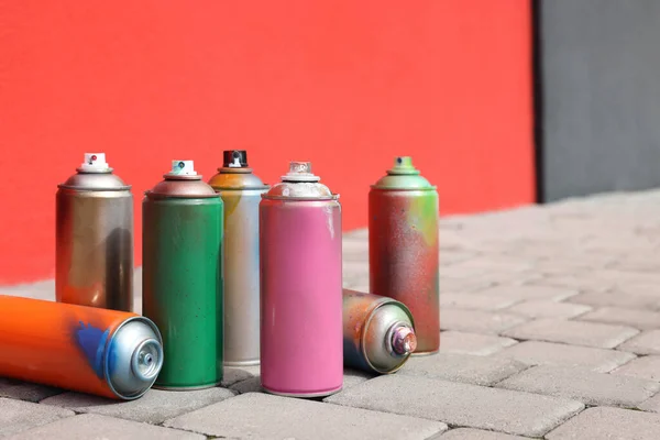 Cans Different Spray Paints Pavement Wall Space Text — Stock Photo, Image