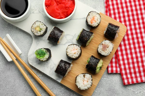 Flat lay composition with sushi rolls on grey table