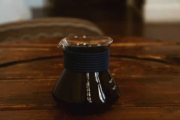 stock image Cup of aromatic coffee on wooden table in cafe