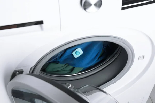 Water softener tablet on clothes in washing machine