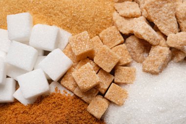 Different types of sugar as background, closeup clipart