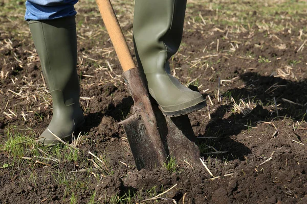 stock image Man digging soil with shovel in field, closeup