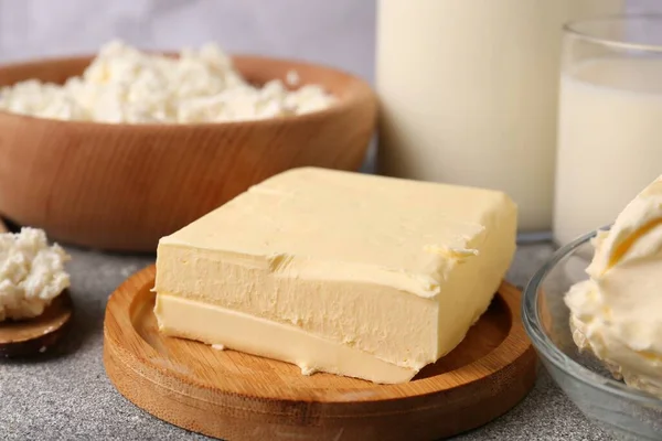 stock image Piece of tasty homemade butter and dairy products on grey table, closeup