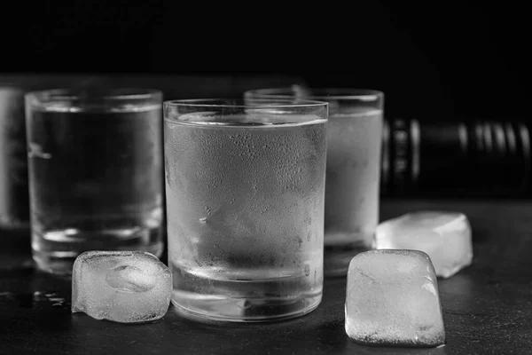 Vodka Bicchierini Con Ghiaccio Sul Tavolo Sfondo Nero Primo Piano — Foto Stock