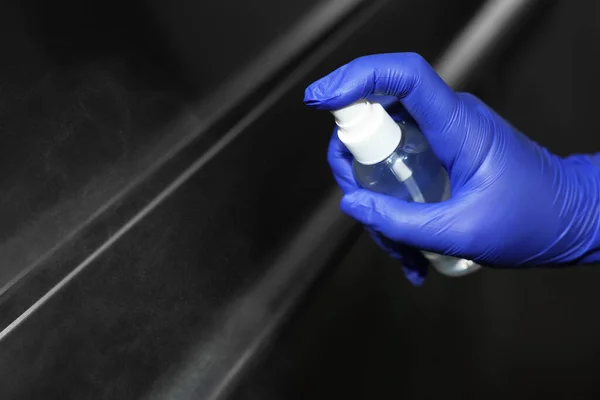 stock image Woman cleaning elevator`s handrails with detergent, closeup